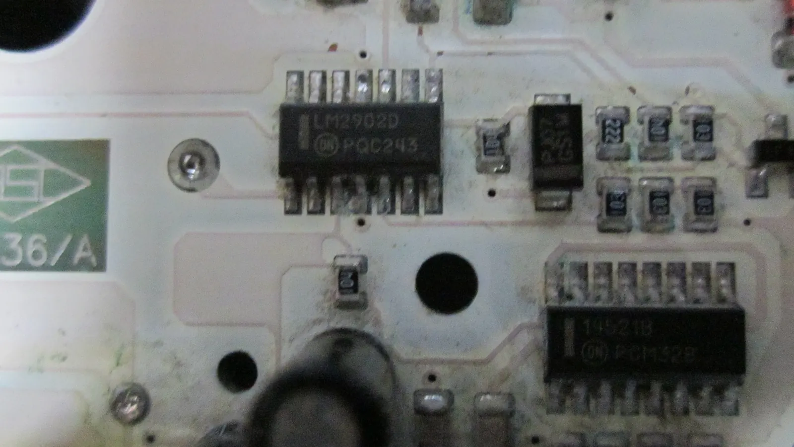 Close-up of a white printed circuit board with electronic components